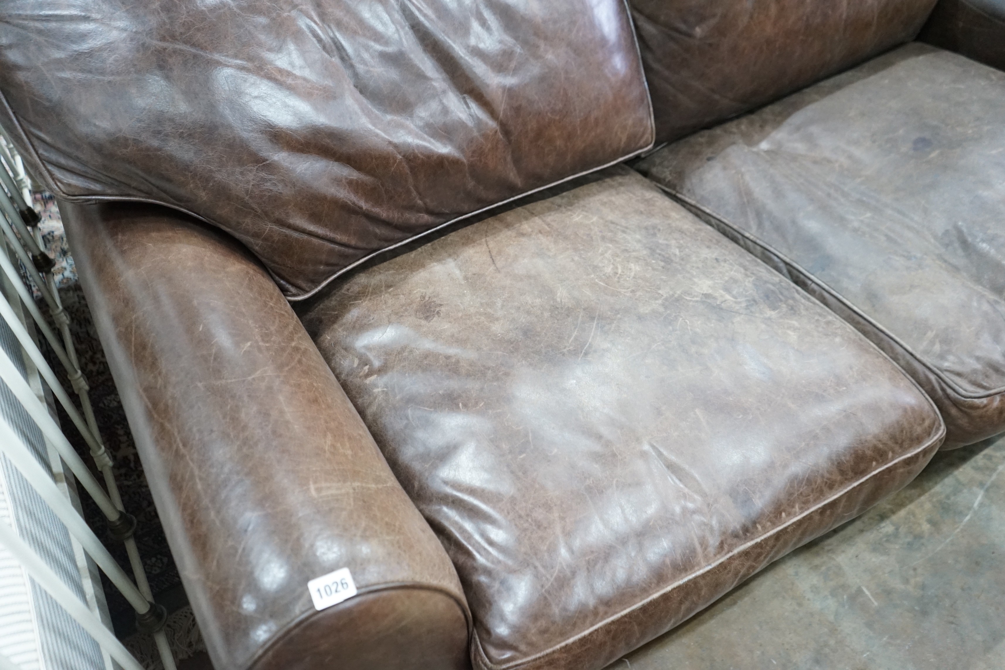A Laura Ashley brown leather sofa bed, width 170cm, depth 96cm, height 86cm